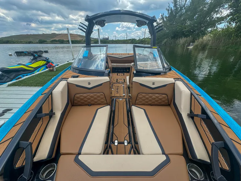 Slide: The Image of 2024 Varatti Z2373 boat interior with luxurious seating and modern design on a lake. - 23