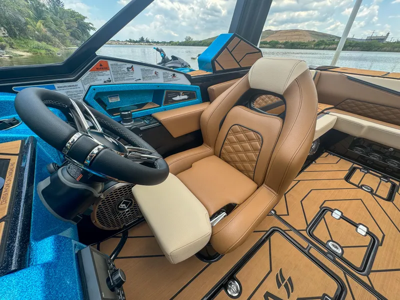 Slide: The Image of 2024 Varatti Z2373 boat interior with tan leather seats and blue dashboard. - 24