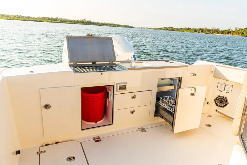 Slide: The Image of 2026 Boston Whaler 330 Vantage boat interior with foldable seating and dual engines. - 11