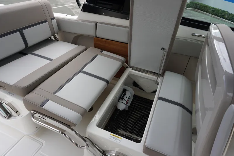 Slide: The Image of 2026 Boston Whaler 330 Vantage interior seating with storage compartment open. - 16