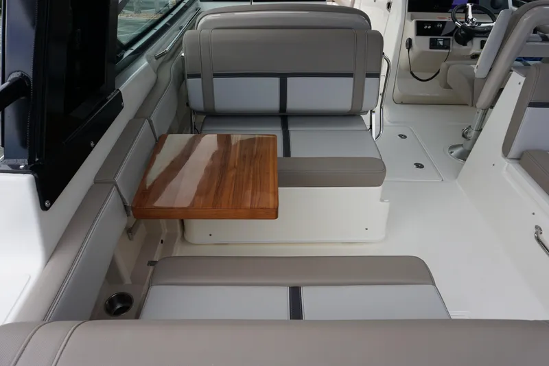 Slide: The Image of 2026 Boston Whaler 330 Vantage interior with seating and wooden table. - 20