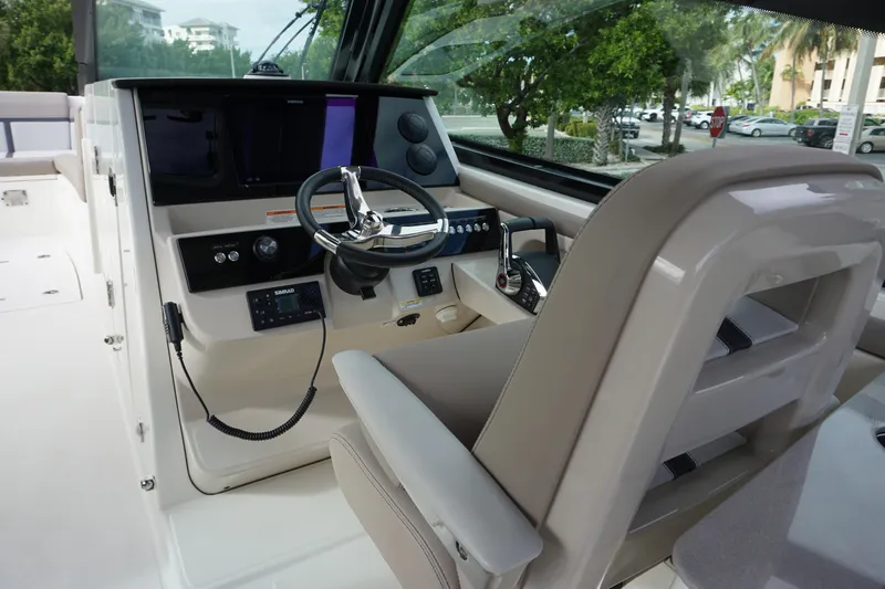 Slide: The Image of 2026 Boston Whaler 330 Vantage helm with modern controls and comfortable seating. - 26