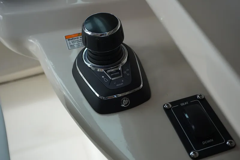 Slide: The Image of Control panel of 2026 Boston Whaler 330 Vantage boat, featuring joystick and seat adjustment. - 28