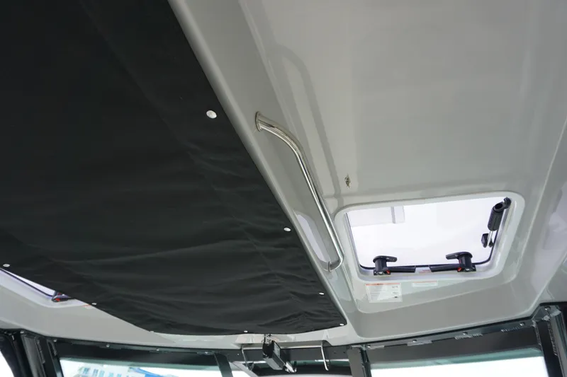 Slide: The Image of Interior view of 2026 Boston Whaler 330 Vantage boat roof with hatch and handle. - 32