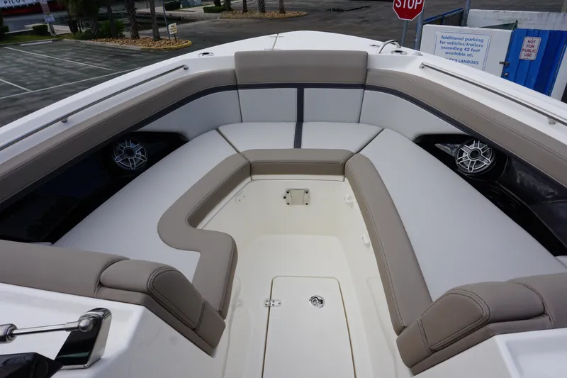 Slide: The Image of 2026 Boston Whaler 330 Vantage boat interior with cushioned seating and speakers. - 36