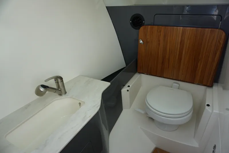 Slide: The Image of 2026 Boston Whaler 330 Vantage boat bathroom with sink and toilet. - 47