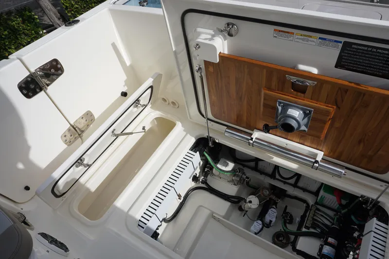 Slide: The Image of 2026 Boston Whaler 330 Vantage boat interior, showcasing storage and mechanical components. - 51