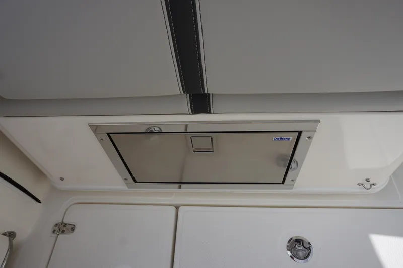 Slide: The Image of 2026 Boston Whaler 330 Vantage boat interior with stainless steel storage compartment. - 53