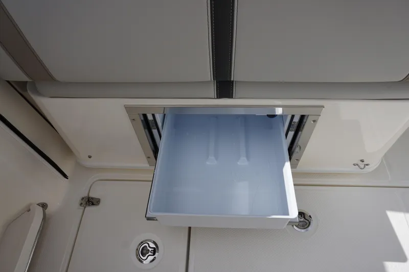 Slide: The Image of 2026 Boston Whaler 330 Vantage boat storage compartment with open drawer. - 54