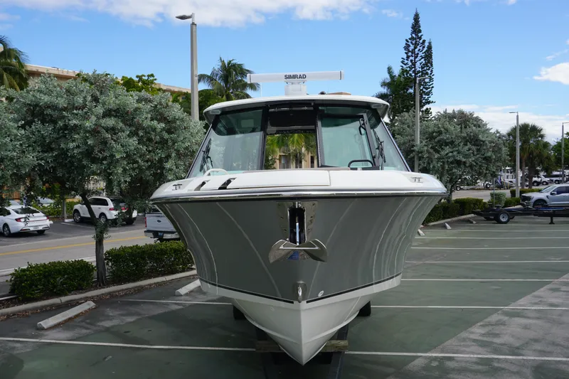 Slide: The Image of 2026 Boston Whaler 330 Vantage boat in a parking lot, front view. - 7