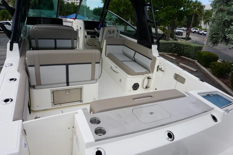 Slide: The Image of 2026 Boston Whaler 330 Vantage boat interior with seating and storage features. - 8
