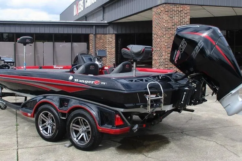 Slide: The Image of 2020 Ranger Z519 boat with powerful outboard motor, parked outside a dealership. - 3