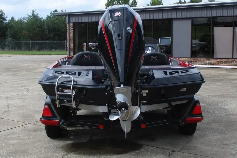 Slide: The Image of 2020 Ranger Z519 boat, rear view with motor and ladder, parked outdoors. - 4