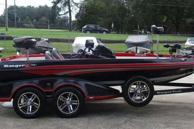 Slide: The Image of 2020 Ranger Z519 boat with sleek design and dual-axle trailer parked outdoors. - 7