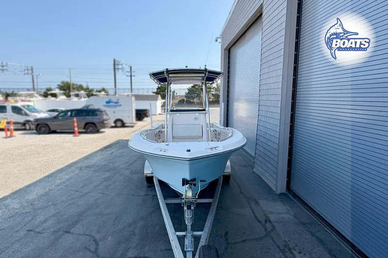 Slide: The Image of 2013 Grady-White Fisherman 209 boat on trailer, parked outside a building. - 3