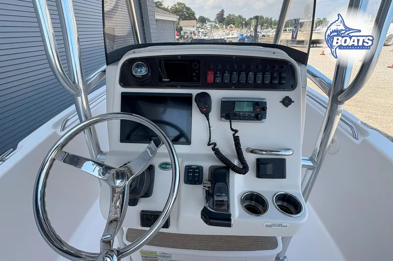 Slide: The Image of 2013 Grady-White Fisherman 209 boat console with steering wheel and navigation controls. - 7