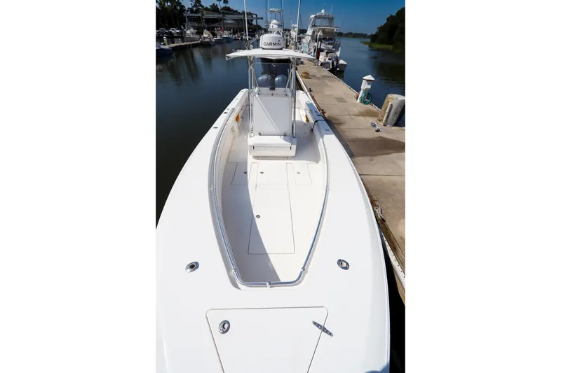 Slide: The Image of 2008 Contender 31 Tournament boat docked at marina, showcasing sleek design and spacious deck. - 13