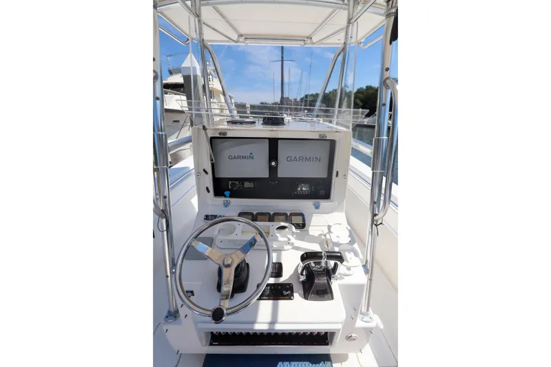 Slide: The Image of 2008 Contender 31 Tournament boat helm with Garmin navigation system and steering wheel. - 15