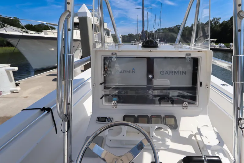 Slide: The Image of 2008 Contender 31 Tournament boat dashboard with Garmin navigation systems at a marina. - 17