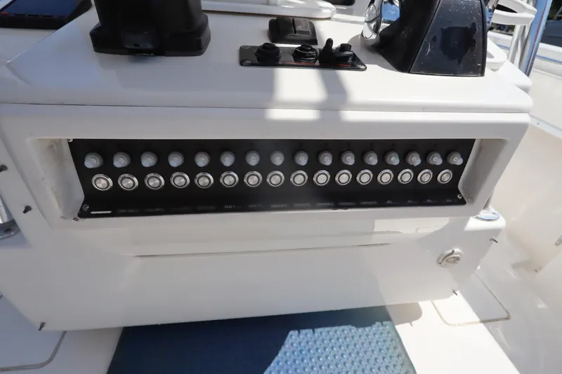 Slide: The Image of Control panel of a 2008 Contender 31 Tournament boat with multiple switches. - 24