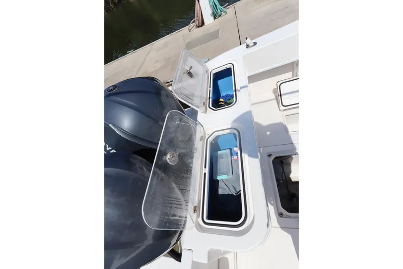 Slide: The Image of 2008 Contender 31 Tournament boat with open storage compartments and Yamaha engines. - 25