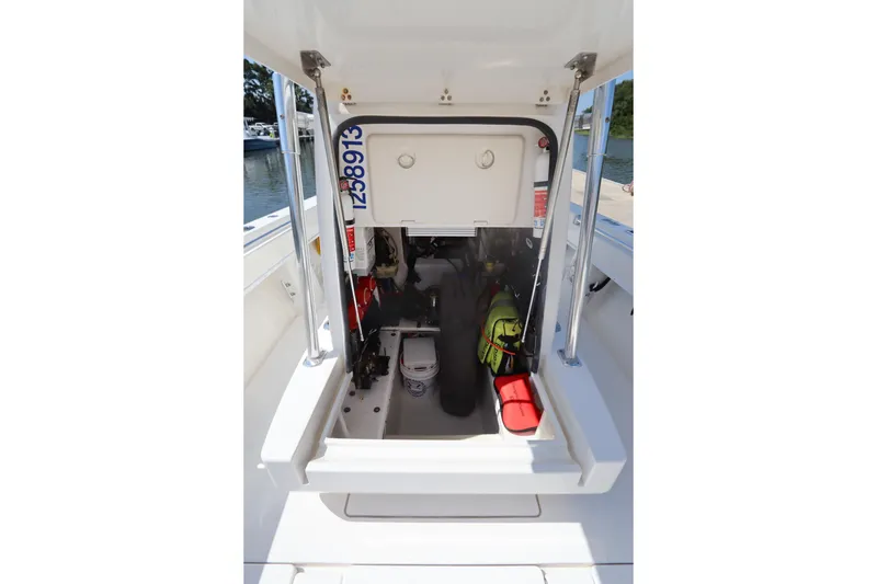 Slide: The Image of 2008 Contender 31 Tournament boat storage compartment with safety equipment and gear. - 28