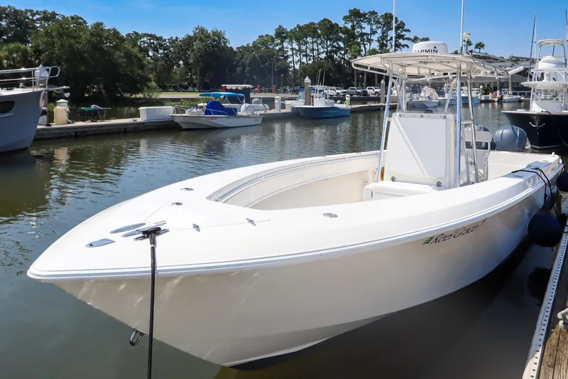 Slide: The Image of 2008 Contender 31 Tournament boat docked in a marina, surrounded by other vessels. - 3