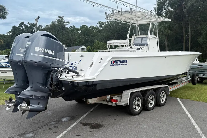 Slide: The Image of 2008 Contender 31 Tournament boat on trailer with dual Yamaha engines. - 34