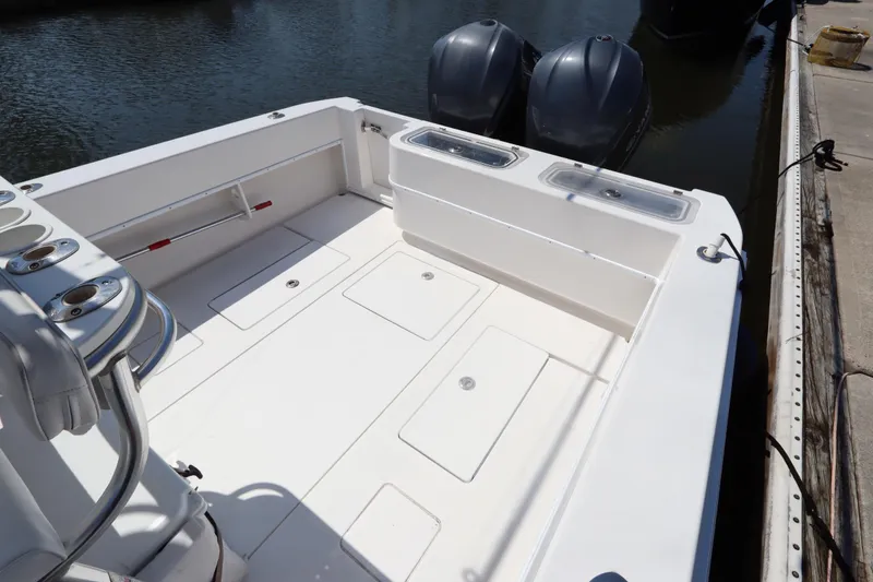 Slide: The Image of 2008 Contender 31 Tournament boat deck with dual outboard motors at dock. - 5