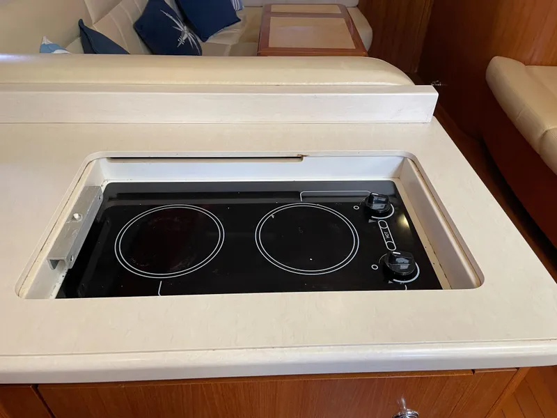 Slide: The Image of 2005 Tiara Yachts 4400 Sovran kitchen with built-in electric stove. - 14