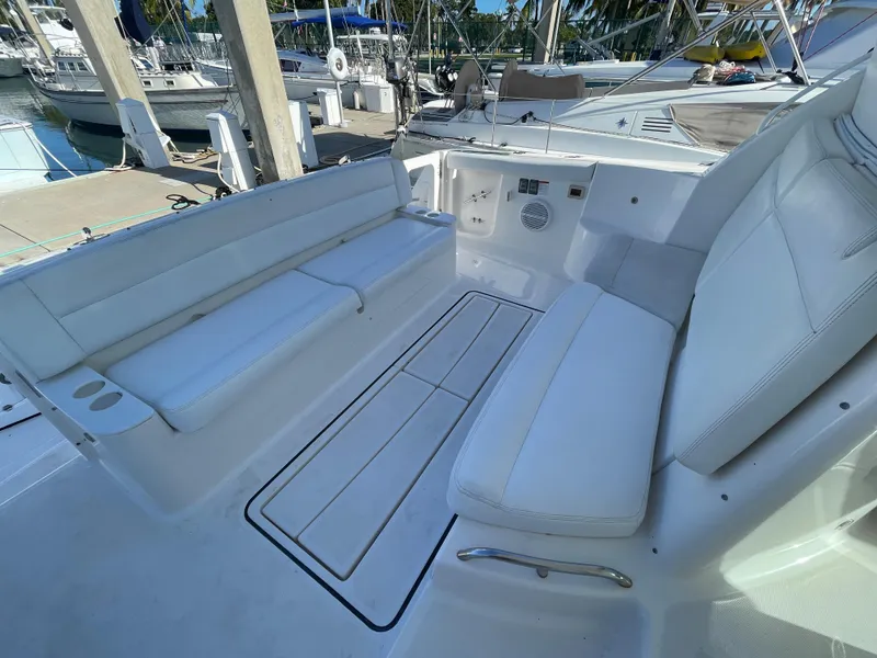 Slide: The Image of 2005 Tiara Yachts 4400 Sovran cockpit with white seating and marina view. - 2