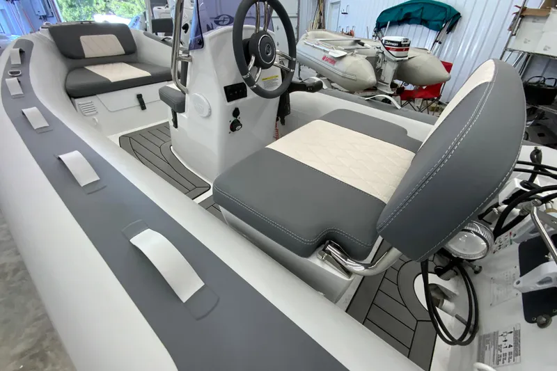 Slide: The Image of 2026 Gala A330L boat interior with gray and white seating, steering wheel, and controls. - 1