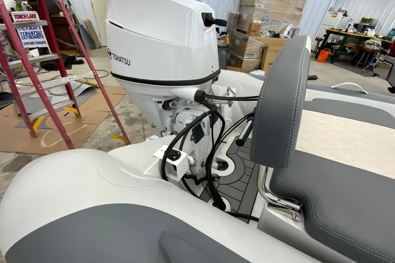 Slide: The Image of Interior view of a 2026 Gala A330L boat with Tohatsu engine in a workshop. - 10