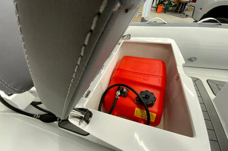 Slide: The Image of Gala A330L 2026 boat storage compartment with red gasoline tank. - 11