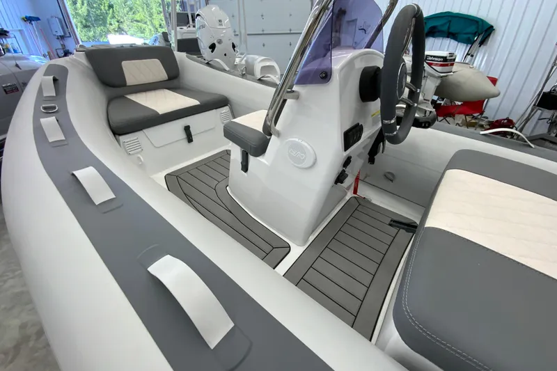 Slide: The Image of Interior of 2026 Gala A330L boat with modern seating and steering console. - 2