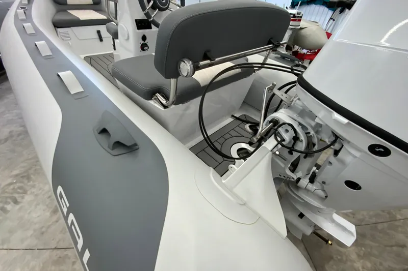 Slide: The Image of 2026 Gala A330L inflatable boat interior with steering console and outboard motor. - 4