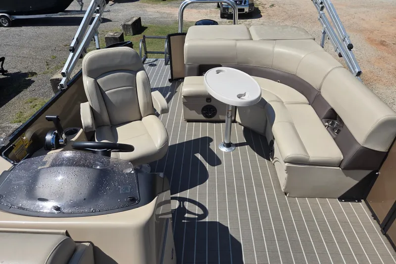 Slide: The Image of 2023 Bentley Pontoons Legacy Cruise interior with beige seating and steering console. - 13