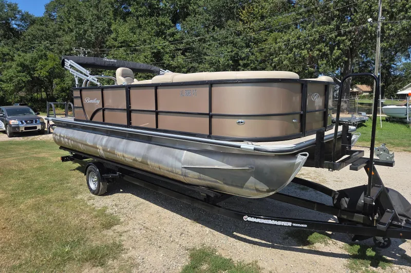 Slide: The Image of 2023 Bentley Pontoons Legacy Cruise on trailer, parked outdoors. - 3