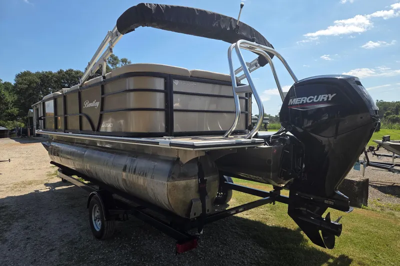 Slide: The Image of 2023 Bentley Pontoons Legacy Cruise with Mercury outboard motor on a trailer. - 6