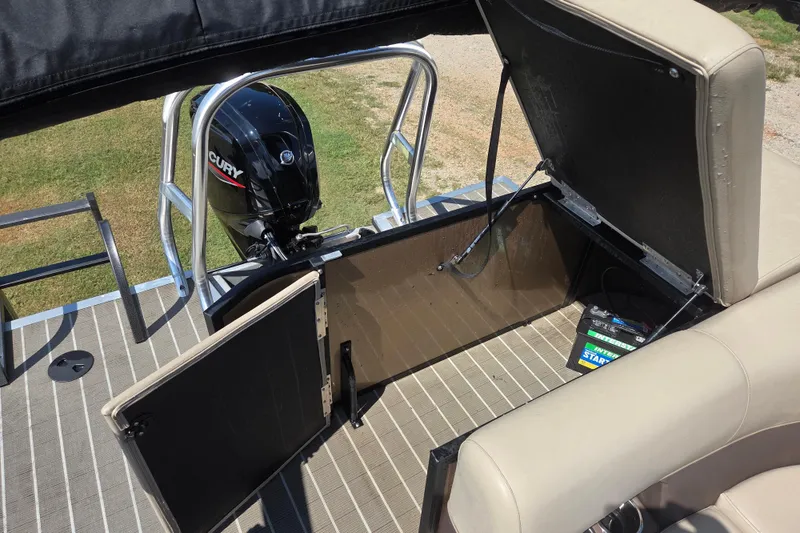 Slide: The Image of 2023 Bentley Pontoons Legacy Cruise with Mercury outboard motor and open storage compartment. - 7