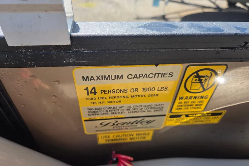 Slide: The Image of 2023 Bentley Pontoons Legacy Cruise capacity label, 14 persons or 1900 lbs, safety warnings. - 8