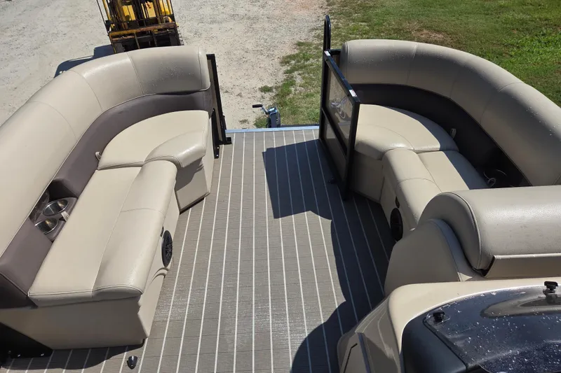 Slide: The Image of 2023 Bentley Pontoons Legacy Cruise interior with beige seating and cup holders. - 9