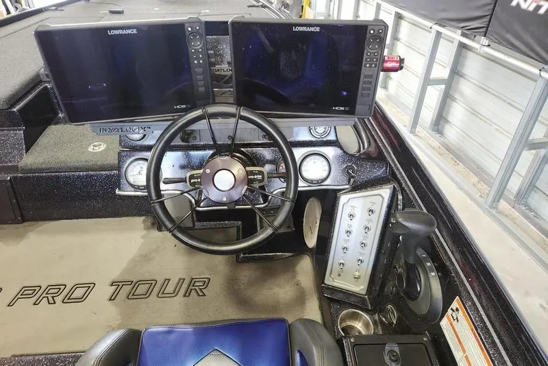 Slide: The Image of 2021 Blazer 650 Pro Tour boat in garage, rear view with motor and license plate. - 2