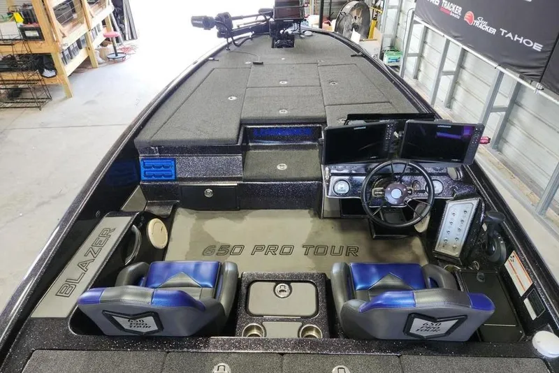 Slide: The Image of 2021 Blazer 650 Pro Tour boat dashboard with dual Lowrance displays and steering wheel. - 3