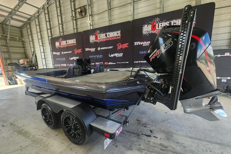 Slide: The Image of 2021 Blazer 650 Pro Tour boat with Mercury Pro XS engine in a showroom. - 5