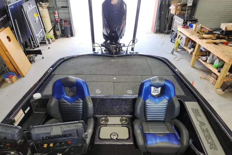 Slide: The Image of 2021 Blazer 650 Pro Tour boat interior with blue seats and Lowrance electronics. - 7