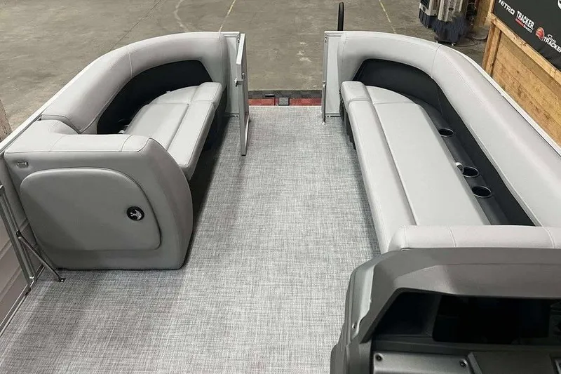 Slide: The Image of 2026 Sun Tracker PARTY BARGE® 18 DLX interior with gray seating and spacious layout. - 4