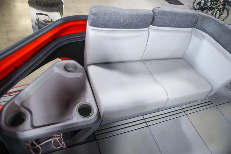 Slide: The Image of 2022 Sea Doo Switch interior with white seating and cup holders. - 11