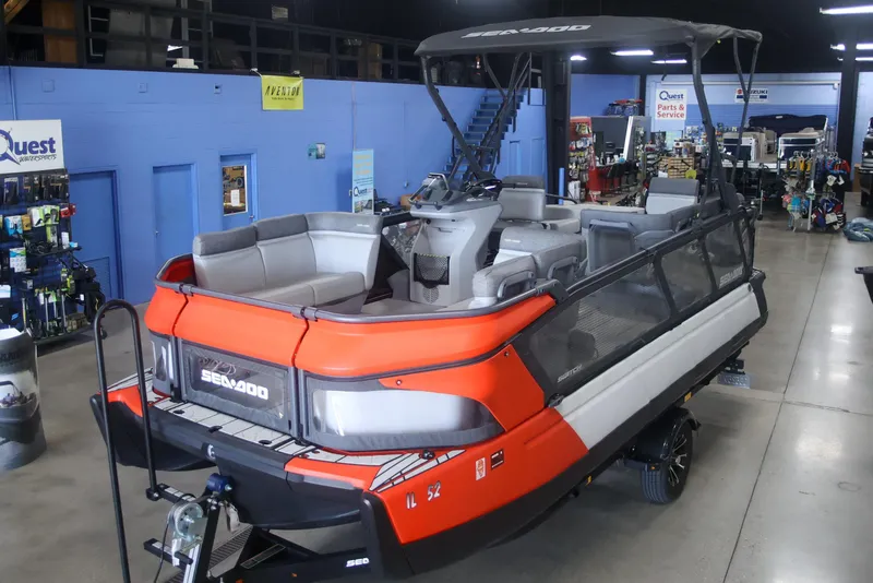 Slide: The Image of 2022 Sea Doo Switch pontoon boat displayed in a showroom setting. - 6