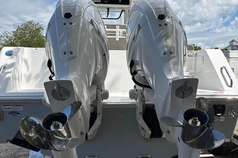Slide: The Image of 2026 Sea Hunt Gamefish 25 with dual outboard motors, rear view. - 12